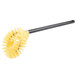 A yellow plastic Carlisle toilet bowl brush with a black handle.
