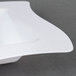 A white Fineline Wavetrends plastic bowl with a curved edge.