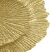 A close up of a Charge It by Jay Reef Gold Glass Charger Plate with a wavy design.