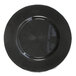 A close up of a black Charge It by Jay glass charger plate with a circular starburst pattern.