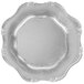 A white background with a silver Charge It by Jay Baroque charger plate with a scalloped edge.