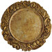 A gold Charge It by Jay plastic charger plate with a round center and a floral design.