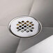 A close-up of a stainless steel drain in an Advance Tabco floor mounted mop sink.