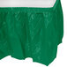 A green plastic table skirt with a white top.