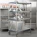 A MetroMax metal cart with dishes on it.