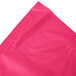 A hot magenta pink plastic table skirt on a white background.