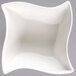 An American Metalcraft Prestige white porcelain bowl with a wavy edge.