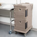 A grey Cambro Ultra Camcart food pan carrier on wheels.
