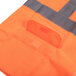 A close up of a Cordova orange safety vest with reflective stripes.