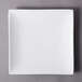 A 10 Strawberry Street Whittier white square porcelain coupe plate on a gray surface.