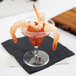 A shrimp in a Fineline Tiny Toasts plastic cup with a garnish on top.