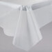 A clear plastic tablecloth on a white table with a crease.