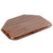 A Cambro Country Oak fiberglass trapezoid tray on a wooden surface.