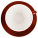 A red and white coffee cup and saucer on a white background.