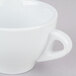A close-up of a CAC white Venice cup with a handle.