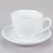 A close up of a CAC white cup and saucer with a white handle.