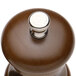 A close up of a Chef Specialties walnut pepper mill with a silver button on top.