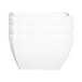 A stack of white square melamine bowls with a wavy design.