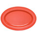 A red oval melamine platter with a coral rim.