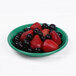An Elite Global Solutions Rio Autumn Green melamine coffee saucer with a bowl of strawberries and blueberries on it.