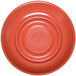 A close-up of a coral melamine coffee saucer with a circle in the middle.