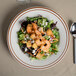 A Tuxton brown speckle narrow rim china pasta/salad bowl filled with salad with shrimp and croutons.