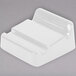 A white Elite Global Solutions wedge for trays with curved edges.