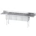 A stainless steel Advance Tabco four compartment sink with two drainboards.