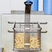 A Cooking Performance Group fryer basket with french fries in it.