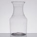 A clear Fineline Tiny Temptations mini wine pitcher on a white surface.