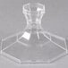 A clear glass object with a hexagon shaped base.