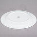 A 10 Strawberry Street Bistro round white porcelain charger plate.