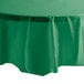 A Creative Converting emerald green plastic table cover on a white table.