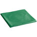 A green plastic table cover folded up on a white background.