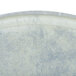 A close-up of a Cambro antique parchment oval tray with a white surface.