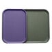 Two purple Cambro trays with a purple lid on a counter.