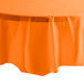 A Sunkissed Orange OctyRound plastic table cover on a table.
