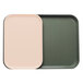 A close-up of a grey Cambro tray with green and light peach inserts.