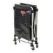 A black Rubbermaid X-Frame rolling laundry cart with wheels and a black bag.