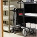 A Rubbermaid X-Frame laundry cart with towels on it.