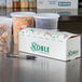 A white box of Noble Products 1" Removable Day of the Week labels on a counter with food containers.
