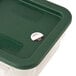 A plastic container with a green lid holding Noble Products 1" Removable Day of the Week label rolls.