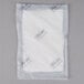 A white plastic bag with a white label reading "White 5" x 7" Absorbent Meat, Fish, and Poultry Pad 75 Grams" containing a white object.