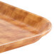 A close up of a Cambro light basketweave fiberglass tray with a rectangular shape.