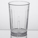A clear plastic tumbler with a handle.