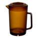 A brown glass pitcher with a handle and lid.