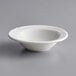 A white Tuxton Sonoma china bowl with an embossed rim on a gray surface.