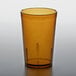 An amber plastic tumbler with a crackled surface on a table.