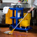 Lavex Janitorial Blue Cleaning / Janitor Cart Kit with Yellow Mop Bucket, Wet Floor Sign, Mop, and Caddy Main Thumbnail 5