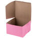 A pink bakery box with a brown lid.